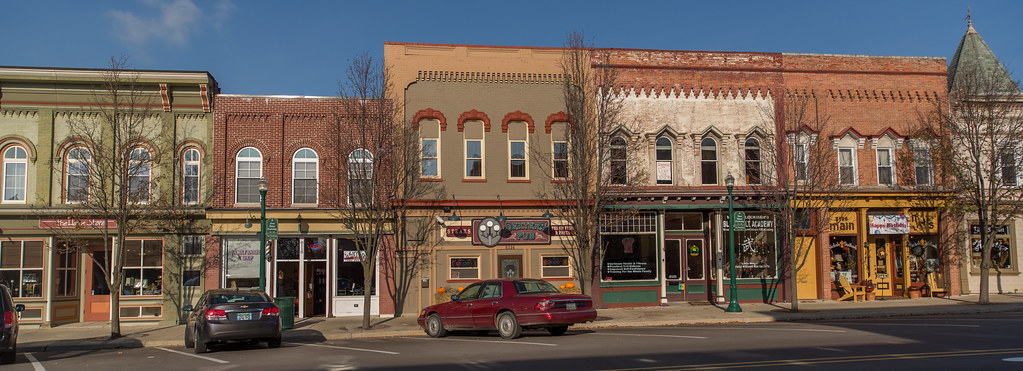 Colorful historic storefronts on a sunny main street in downtown Dexter, Michigan